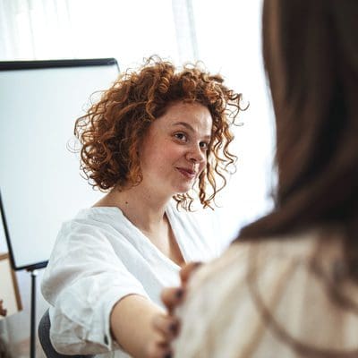 women in group therapy supporting each other - programs