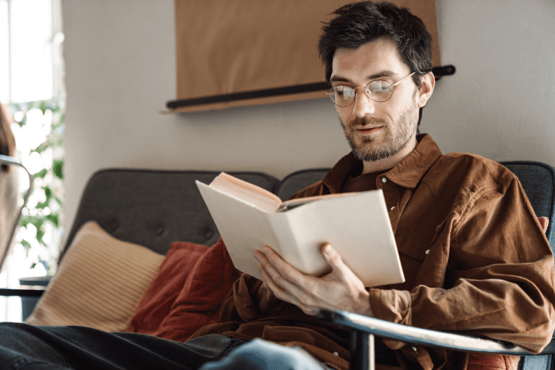 Man reading book in chair - Recovery