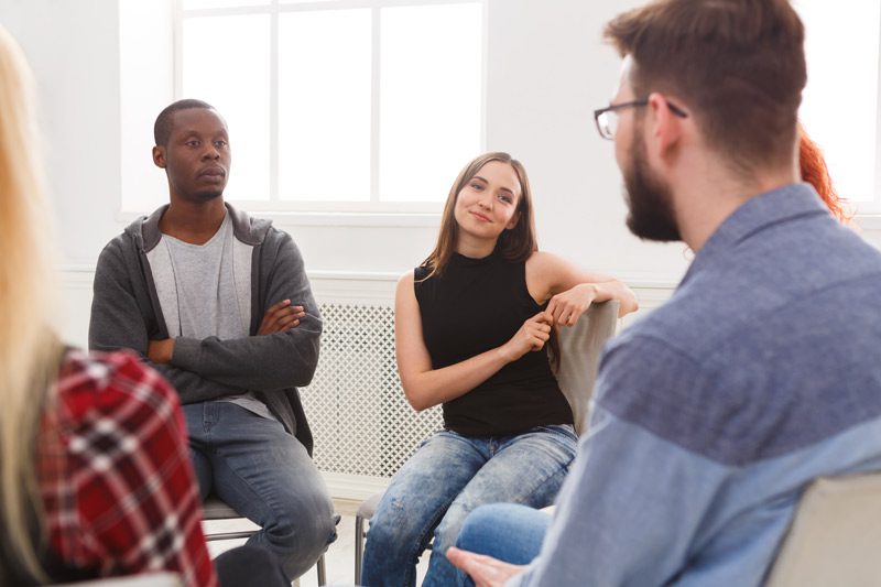 diverse group of individuals in a group therapy setting - addiction stigma