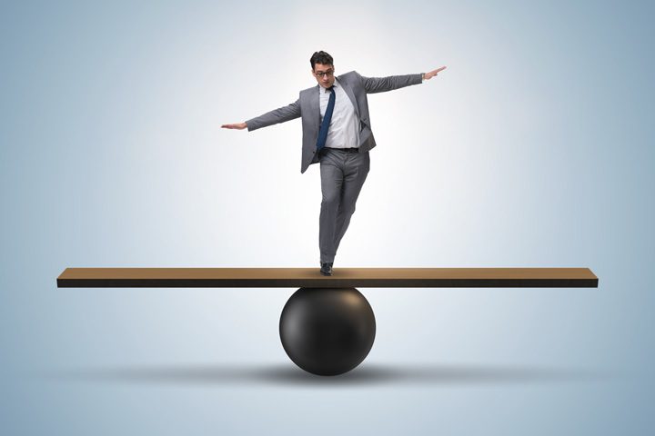 burnout treatment centers, Boredom & Burnout in Recovery, man in business suit standing on wooden board that is held up by a large solid ball - balance concept - sweet spot